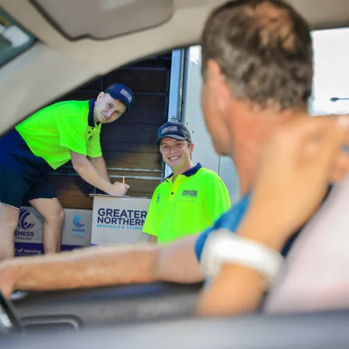 Two Cairns Removalists loading a truck as home owners leave their property.