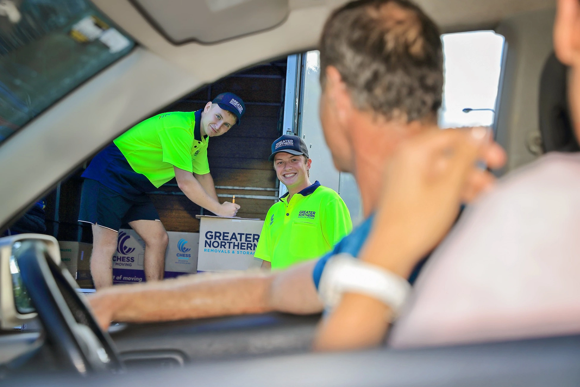 Two Cairns Removalists loading a truck as home owners leave their property.